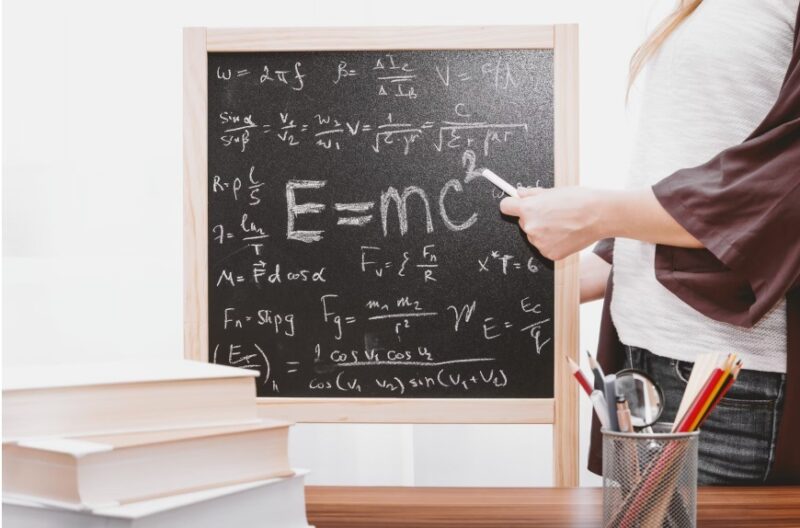 Person teaching with a chalkboard.